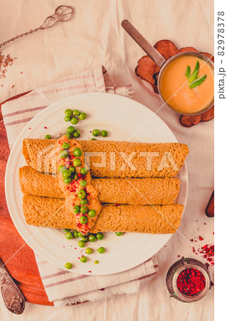 Homemade Coconut flour and turmeric keto wraps with cottage cheese sauce. Low-carb gluten free crepe with curry sauce and sweet corn and green peas on top Homemade Coconut flour and turmeric keto wraps with cottage cheese sauce. Low-carb gluten free crepe with curry sauce and sweet corn and green peas on top 82978378