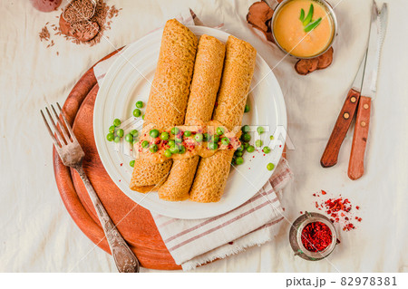 Homemade Coconut flour and turmeric keto wraps with cottage cheese sauce. Low-carb gluten free crepe with curry sauce and sweet corn and green peas on top Homemade Coconut flour and turmeric keto wraps with cottage cheese sauce. Low-carb gluten free crepe with curry sauce and sweet corn and green peas on top 82978381
