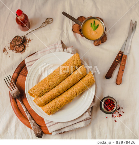 Gluten free crepes from corn, rice flour and potato starch with curry sauce Gluten free crepes from corn, rice flour and potato starch with curry sauce 82978426
