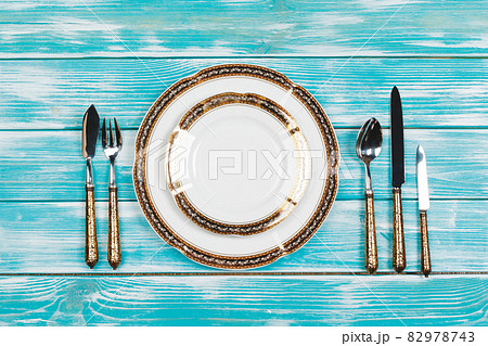 Beautiful table setting on blue wooden background 82978743