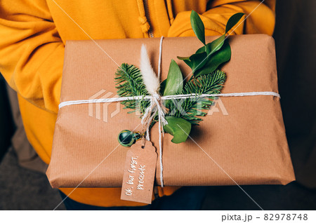 Hands are holding gift in eco paper Hands are holding gift in eco paper 82978748