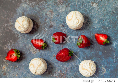 strawberries and marshmallows on a blue metal background. Healthy lifestyle and summer diet detox food concept. Copy space for text 82978873