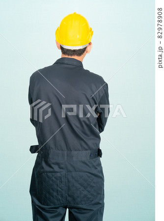 Man in coveralls helmet hardhat Man in coveralls helmet hardhat 82978908