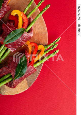 raw beef roulades and fresh vegetable trimmings ready for cooking on a white background raw beef roulades and fresh vegetable trimmings ready for cooking on a white background 82979261