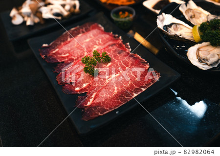 Sliced beef shabu in a black plate in a restaurant 82982064