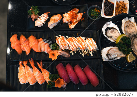 Sushi on a black plate in a Japanese restaurant Sushi on a black plate in a Japanese restaurant 82982077