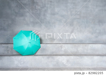 Green umbrella on concrete stairs with blank space on the wall background 82982205
