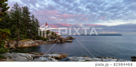 Lighthouse Park on a rocky coast during a dramatic cloudy sunset. 82984468