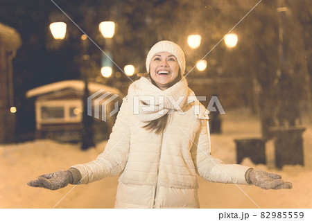 Girl in a night city snowflake Christmas city lights. Christmas and winter holidays concept. 82985559