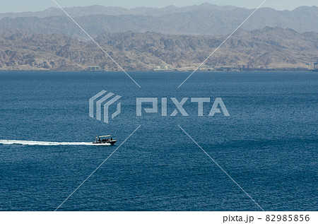Two pleasure boats sail in the Red Sea during the day near the coast of Eilat in Israel the coast of Jordan is visible in the background 82985856