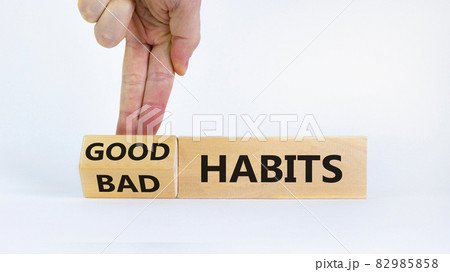 Good habits symbol. Businessman turns a wooden block and changes words 'bad habits' to 'good habits'. Beautiful white background. Business, psychological and good or bad habits concept. Copy space. Good habits symbol. Businessman turns a wooden block and changes words 'bad habits' to 'good habits'. Beautiful white background. Business, psychological and good or bad habits concept. Copy space. 82985858