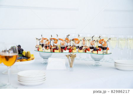 canapes of cheese with fruit, fish with tomatoes and shrimp with sauce in glass. canapes of cheese with fruit, fish with tomatoes and shrimp with sauce in glass. 82986217