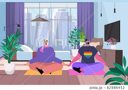 gay practicing yoga exercise in lotus pose LGBT parade pride festival transgender love concept living room interior gay practicing yoga exercise in lotus pose LGBT parade pride festival transgender love concept living room interior 82986452