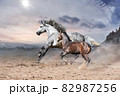 a romantic scene of a rapidly galloping horse with a foal against the backdrop of harsh mountains  82987256