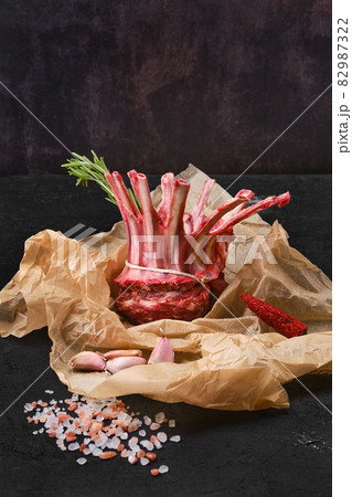 Rolled and tighted rack of lamb on kitchen table 82987322