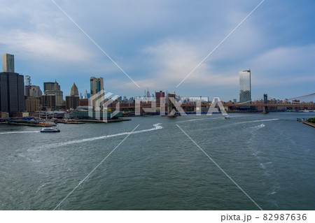 Brooklyn Bridge and Manhattan Bridge with Manhattan New York City skyscrapers city skyline over Hudson River. Brooklyn Bridge and Manhattan Bridge with Manhattan New York City skyscrapers city skyline over Hudson River. 82987636