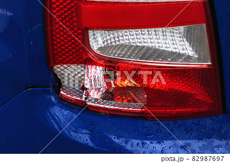 Broken taillight of a blue car closeup Broken taillight of a blue car closeup 82987697