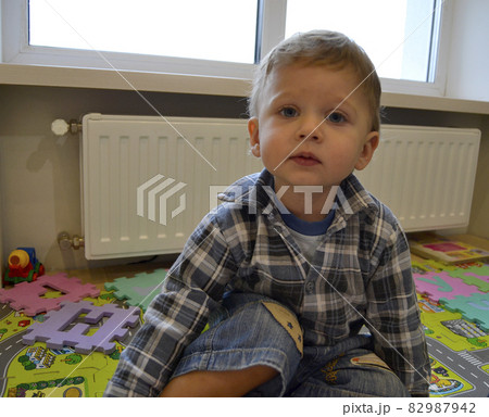 Beautiful baby boy with child face posing photographer Beautiful baby boy with child face posing photographer 82987942