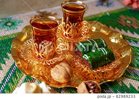 Turkish sweet baklava on metal tray with Turkish tea Turkish sweet baklava on metal tray with Turkish tea 82989233