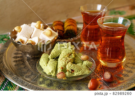 Turkish sweet baklava on metal tray with Turkish tea Turkish sweet baklava on metal tray with Turkish tea 82989260