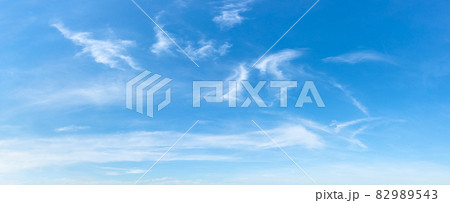 Clear azure sky with few wispy cirrus clouds. 82989543