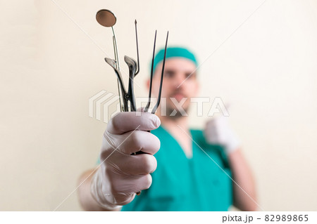 Funny doctor ENT, with instruments in his hands. Funny doctor ENT, with instruments in his hands. 82989865