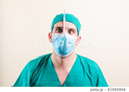 Funny doctor with a scalpel in his hands. Funny doctor with a scalpel in his hands. 82989866