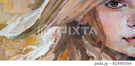 .A woman in a straw hat sits in the sunset. 82990384