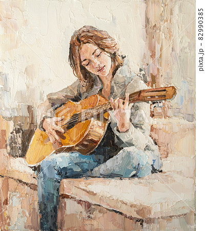 .The girl plays the guitar. 82990385