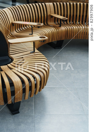 Modern curved wooden bench at the airport Modern curved wooden bench at the airport 82997906
