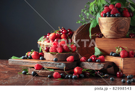Assorted fresh berries with leaves. Assorted fresh berries with leaves. 82998543