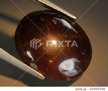 Natural almandine garnet on gray background 83000386