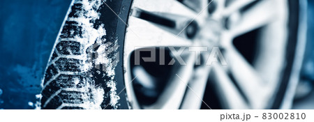 Closeup view of the car's wheel covered with snow Closeup view of the car's wheel covered with snow 83002810