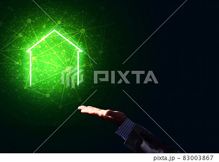 Conceptual image with hand pointing at house or main page icon on dark background Conceptual image with hand pointing at house or main page icon on dark background 83003867
