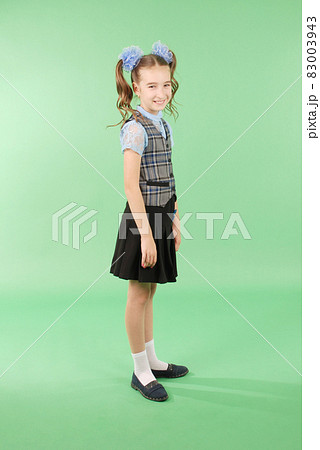 Beautiful young girl in school uniform Beautiful young girl in school uniform 83003943