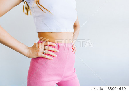 Slim young woman with perfect body standing on white background. 83004630