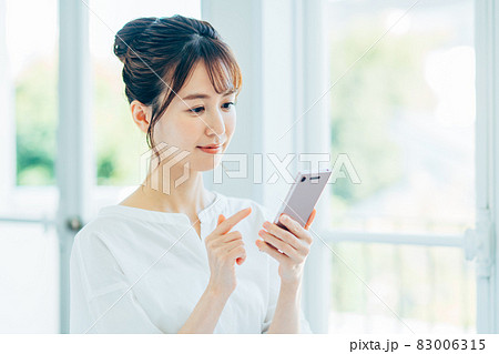スマホを見る若い女性 83006315