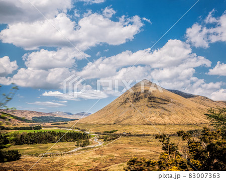 Scottish Highlands with deep valley against cloudy sky in Scotland 83007363