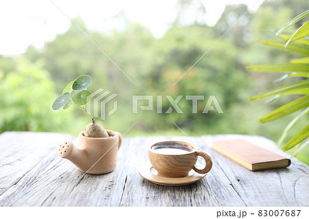 Coffee in wooden cup and Stephania erecta on wooden table 83007687