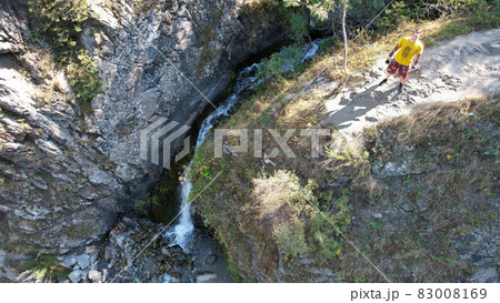 The guy is standing on the edge of the cliff The guy is standing on the edge of the cliff 83008169