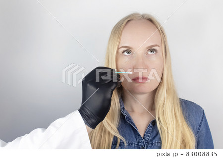 The girl complains to the doctor about the loss of smell. The doctor conducts a sense of smell test. Diagnostics of covid-19. Symptoms of the coronavirus. Quarantine and isolation. Test for sars-cov-2 83008835