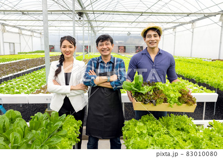 A guy and a woman farmer present on the farm with a smile and pride in their own start-up business in a hydroponic vegetable greenhouse with happiness and joy in the backdrop. A guy and a woman farmer present on the farm with a smile and pride in their own start-up business in a hydroponic vegetable greenhouse with happiness and joy in the backdrop. 83010080