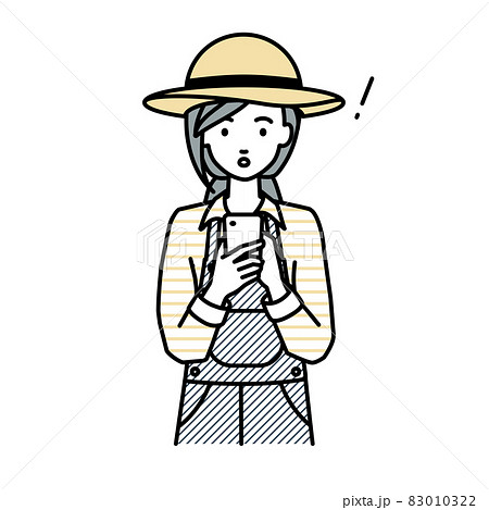 立ってスマートフォンを操作して何かに気づいて驚いた農家の女性 83010322