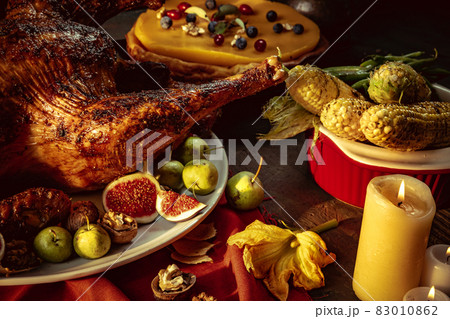 Close-up holiday decorated table with roasted turkey and season traditional vegetables. Thanksgiving day, national traditions 83010862