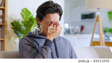 man rubbing his eyes man rubbing his eyes 83011040