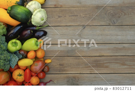 Many different colorful vegetables on a wooden background . Harvest Many different colorful vegetables on a wooden background . Harvest 83012711
