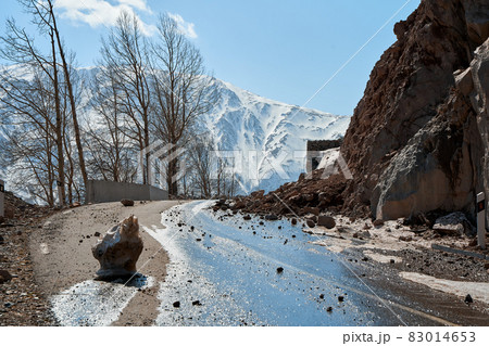 Early spring in the mountains. The rocks fell on the road. Dangerous bugle road. Rockfall in the mountains 83014653