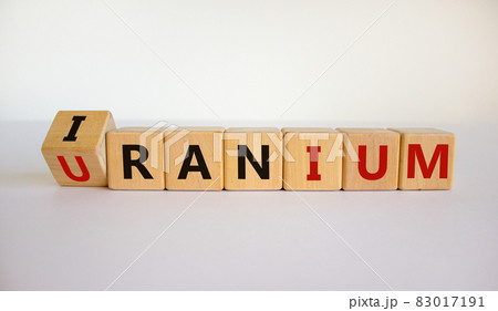Uranium enrichment in Iran symbol. Turned cubes with words 'Iran, uranium'. Beautiful white background, copy space. Business, nuclear technology and uranium enrichment in Iran concept. 83017191