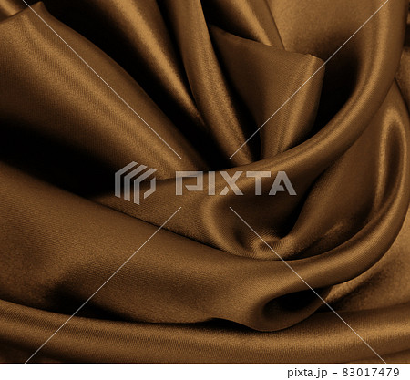 Smooth elegant brown silk or satin texture as abstract background. Luxurious background design. In Sepia toned. Retro style Smooth elegant brown silk or satin texture as abstract background. Luxurious background design. In Sepia toned. Retro style 83017479