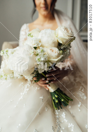 Beautiful wedding bouquet in hands of the bride 83017510